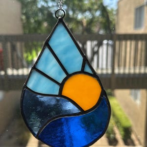 Vibrant Stained Glass Ocean Landscape Suncatcher. Blue sky and tranquil waves brighten any room or make a great gift. Free shipping!